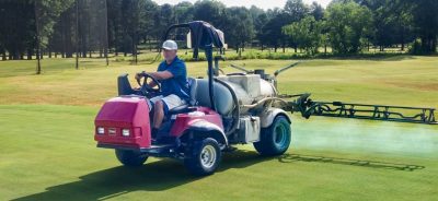 Rob Starr operates a turf sprayer at a golf course.