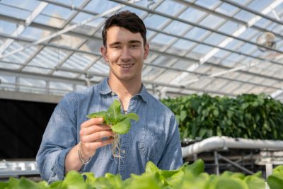 Tucker Bruguiere holding a plant