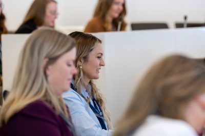 blonde woman sitting among other women